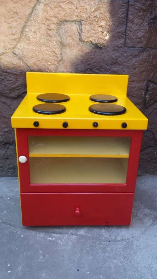 Beautiful kids play stove.
