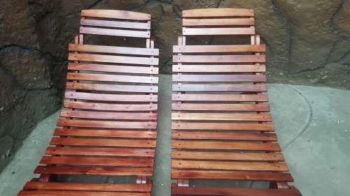 Beautiful pair of wooden garden loungers.