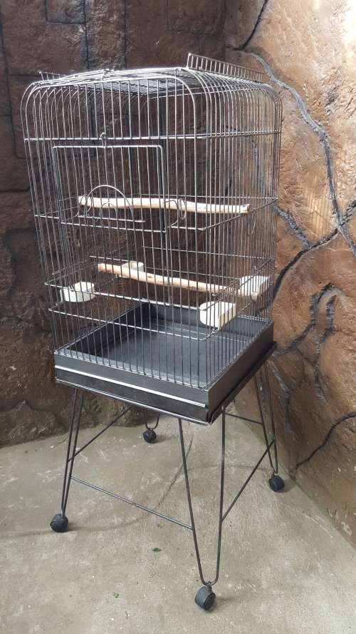 Lovely, large parrot cage on a stand.
