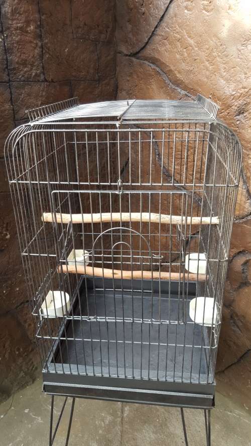 Lovely, large parrot cage on a stand.