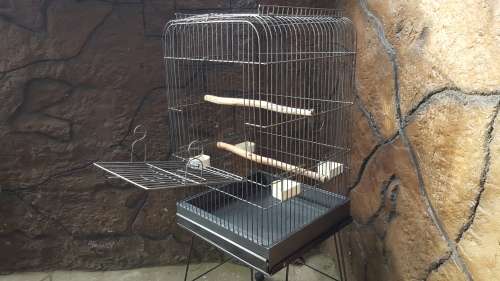 Lovely, large parrot cage on a stand.