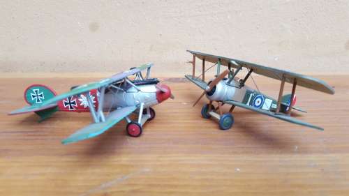Pair of small metal aeroplanes.
