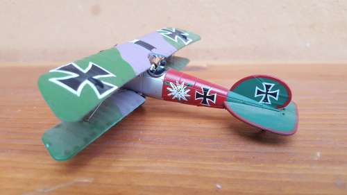 Pair of small metal aeroplanes.