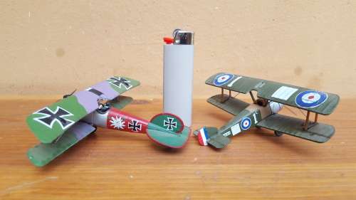 Pair of small metal aeroplanes.