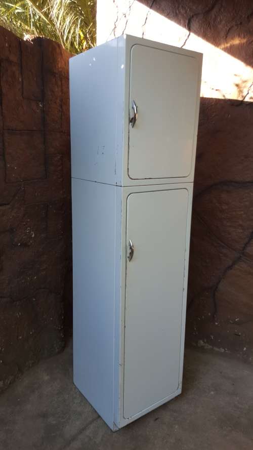 Tall old metal broom cupboard.