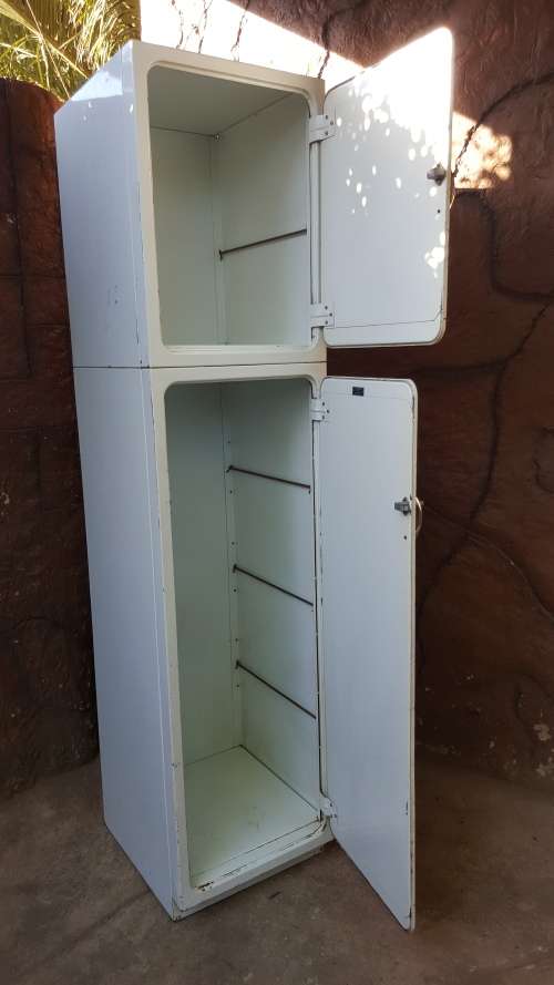 Tall old metal broom cupboard.