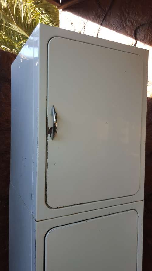 Tall old metal broom cupboard.