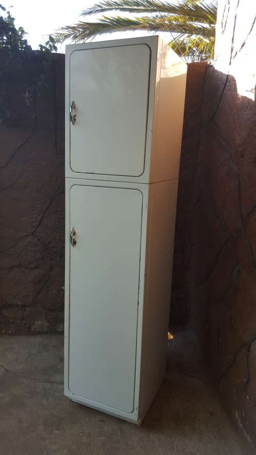 Tall old metal broom cupboard.