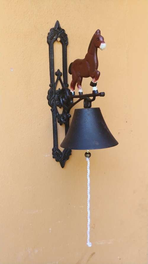 Awesome metal horse outside bell.