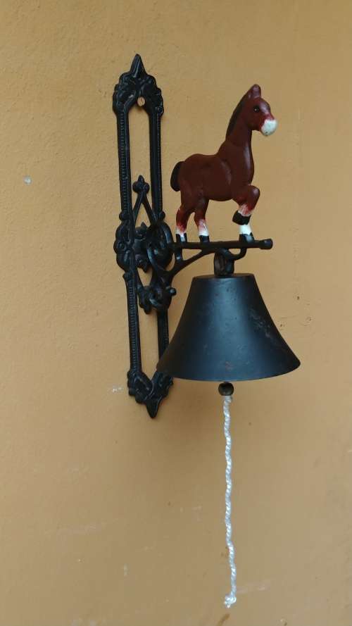 Awesome metal horse outside bell.