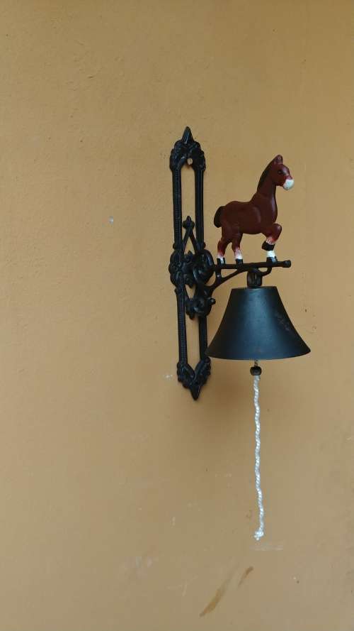 Awesome metal horse outside bell.