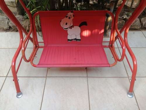 Lovely red toddlers swing.