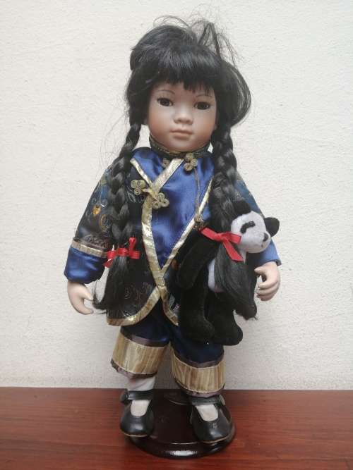 Lovely oriental girl porcelain doll.