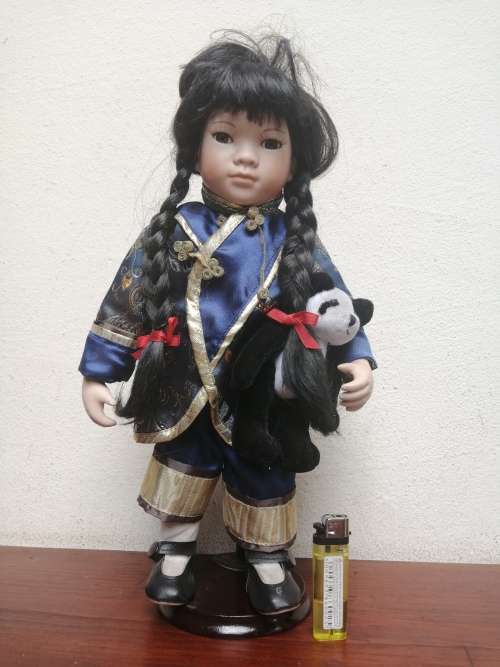 Lovely oriental girl porcelain doll.