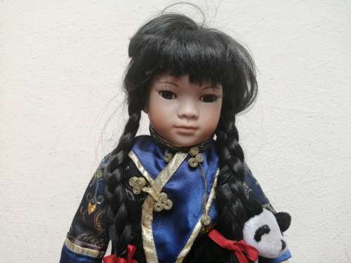 Lovely oriental girl porcelain doll.