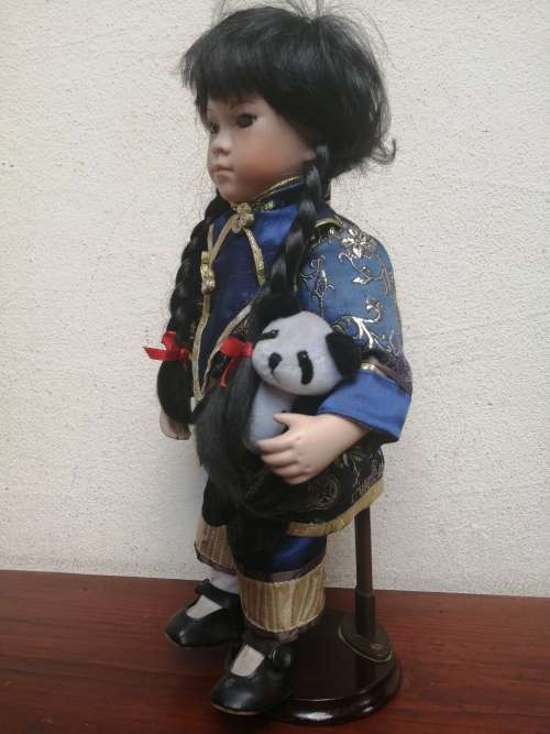 Lovely oriental girl porcelain doll.