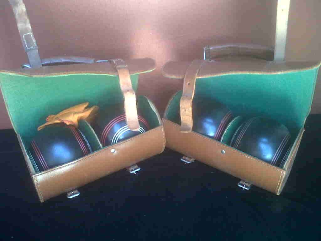 SET OF 4 OLD BOWLING BALLS.