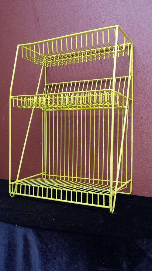 Old yellow metal dish rack
