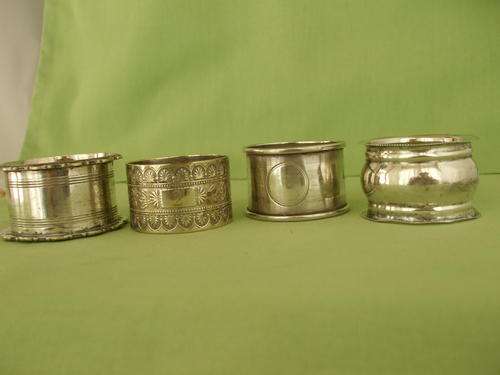 Four Assorted Serviette Rings - Silver and Other