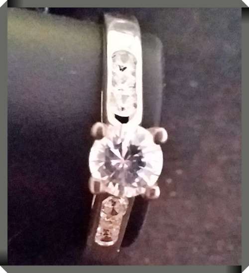 Sterling silver ring with solitaire style main stone and accent CZs