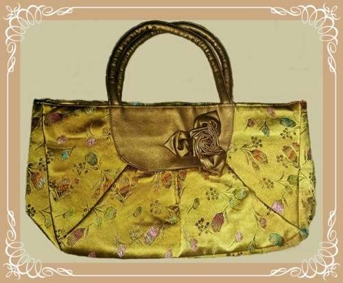 Soft handle bag with bow for day or evening wear