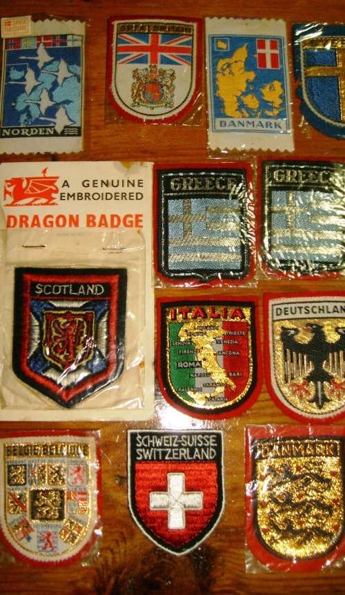 Lot of 22 embroidered cloth badges.