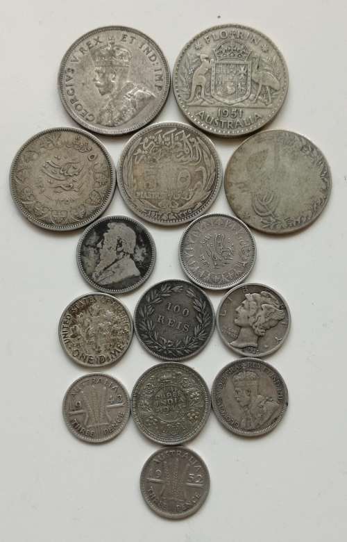 Collection of 14 silver coins from around the world. Some good.