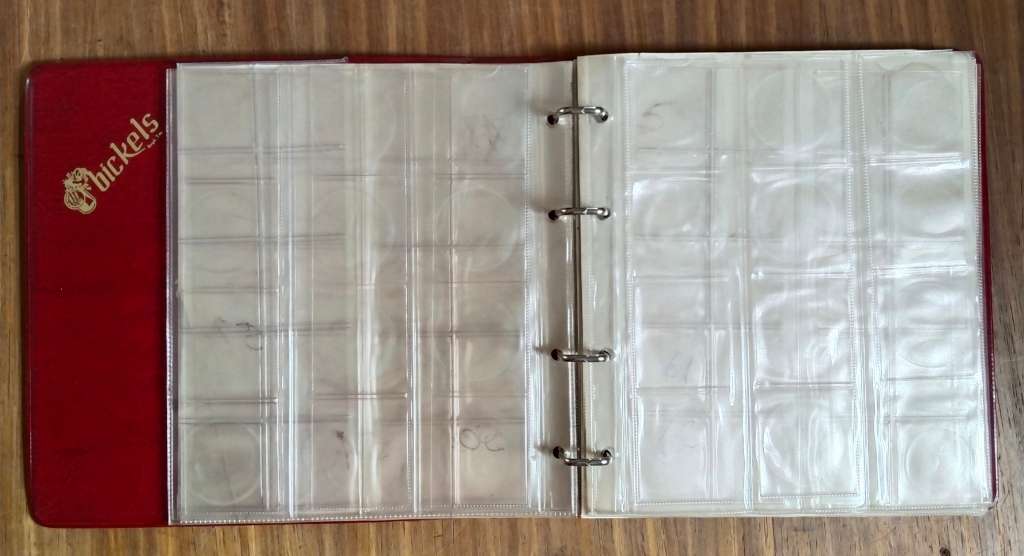 Coin album with 9 empty pages.