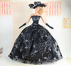 Black Barbie doll dress with silver lace patterning, hat and gloves