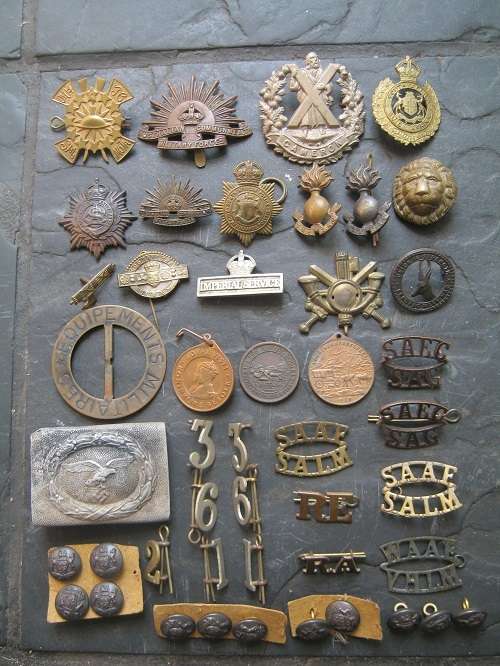 A job lot of 46 Military Badges, buttons, buckles, & medellions from around the world