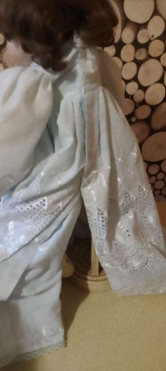 PORCELAIN DOLL - Christening Doll- 55 cm long - ON WOODEN STAND