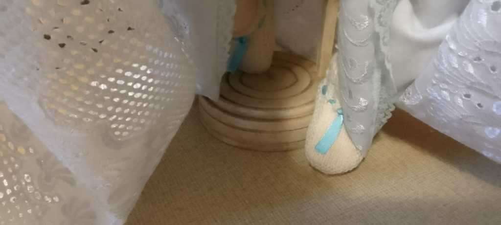 PORCELAIN DOLL - Christening Doll- 55 cm long - ON WOODEN STAND