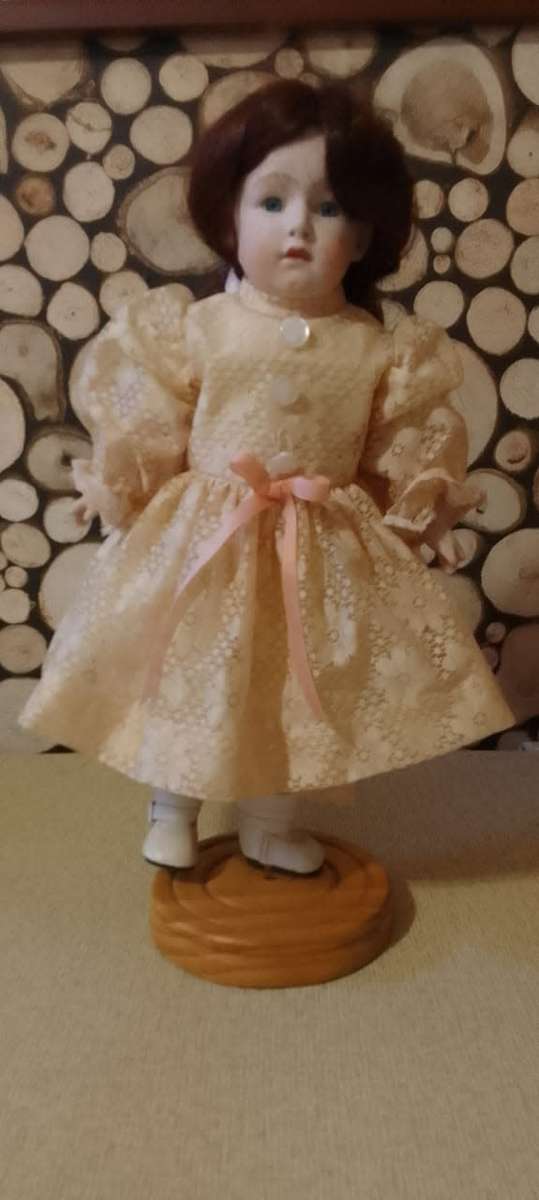 PORCELAIN DOLL - vintage- 40 cm long - ON WOODEN BASE
