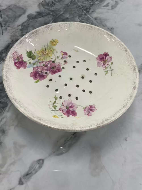 Antique serving bowl with holes