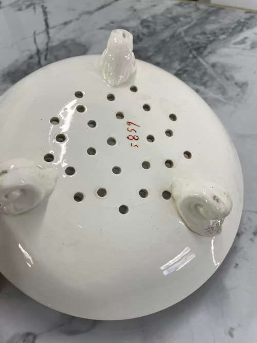 Antique serving bowl with holes