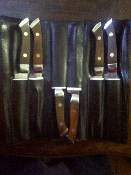 WOODEN HANDLED STEAK KNIVES.
