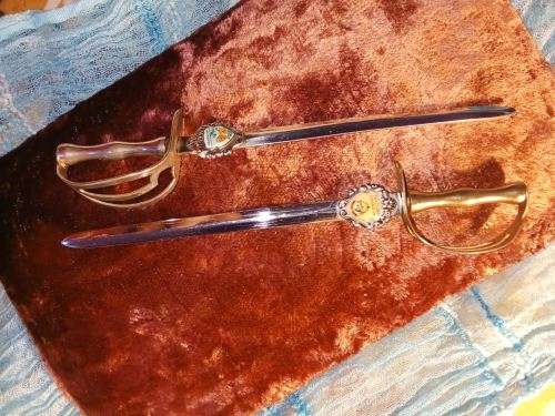 1 x Silver 1 x brass sword. Silver is a Kruger Park Brass is a Swaziland Coronation.