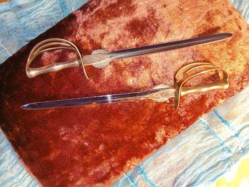 1 x Silver 1 x brass sword. Silver is a Kruger Park Brass is a Swaziland Coronation.