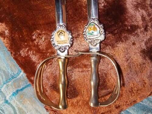 1 x Silver 1 x brass sword. Silver is a Kruger Park Brass is a Swaziland Coronation.