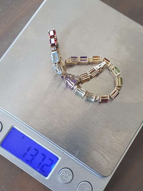 14k tennis bracelet set with various stones and diamond accents