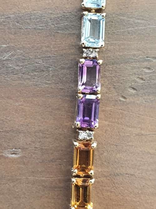 14k tennis bracelet set with various stones and diamond accents