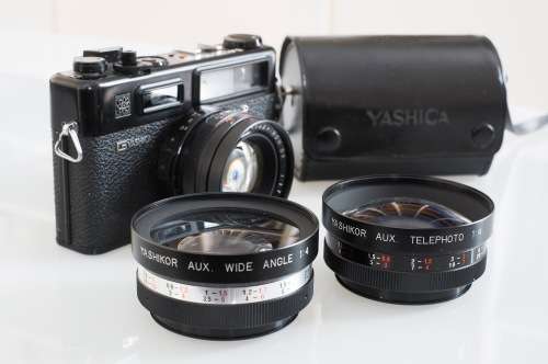 Vintage Yashica Electro 35 rangefinder camera with two extra lenses