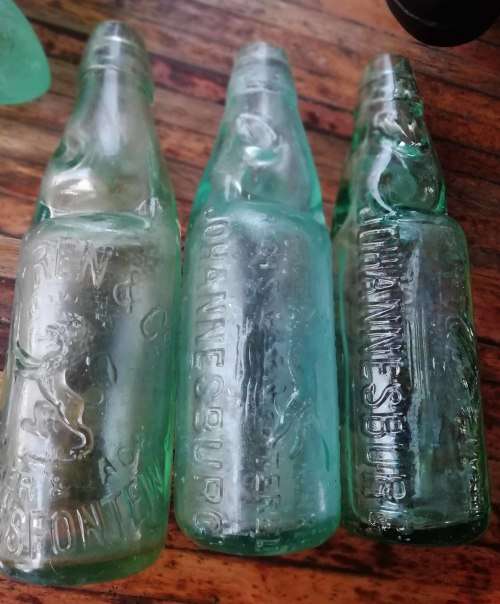 ANTIQUE BOTTLES WITH MARBLE STOPPERS.
