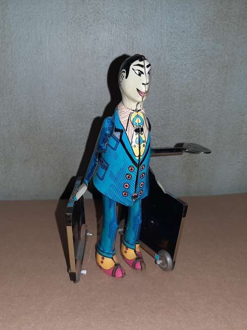 Classic tin toy wind-up Spanish man with two suitcases