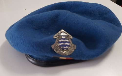 Old blue military beret with badges