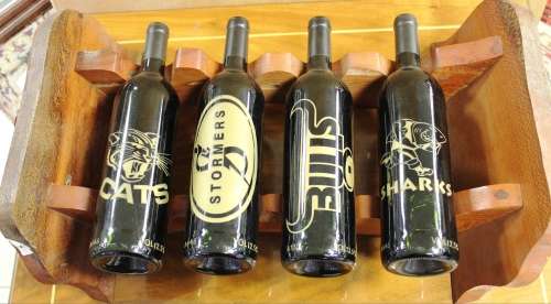 Set of 4 rugby teams bottles on a rack