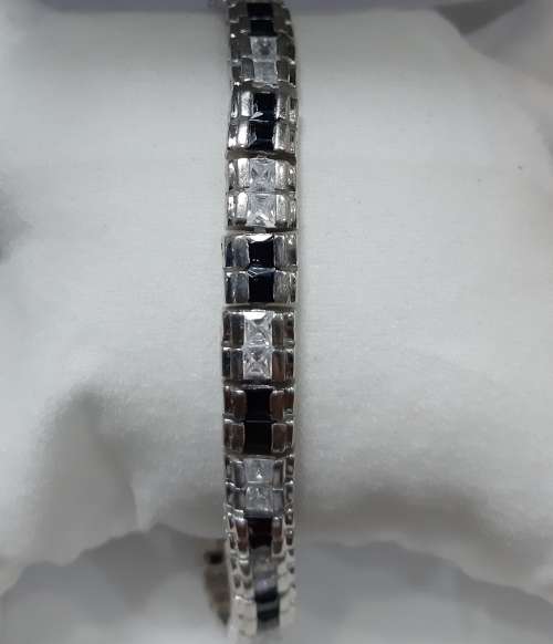 Thickish Sterling Silver tennis bracelet with semi precious blue stone & zirconias