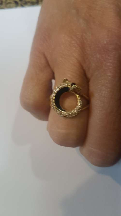 A diamond/black enamel and gold ring copy from the Cartier Jaguar Collection