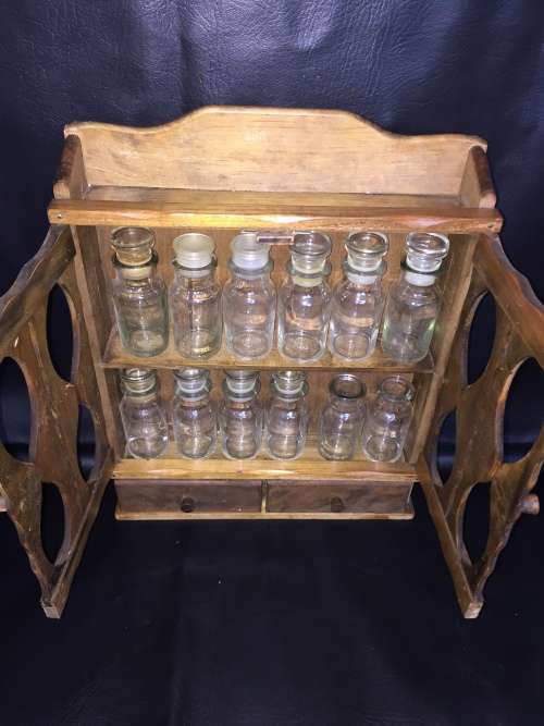 Beautiful wooden spice rack with 12 glass bottles 2 bottles are missing the lids