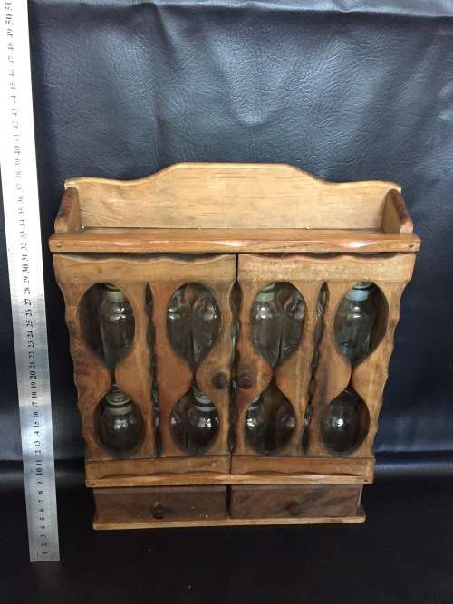 Beautiful wooden spice rack with 12 glass bottles 2 bottles are missing the lids